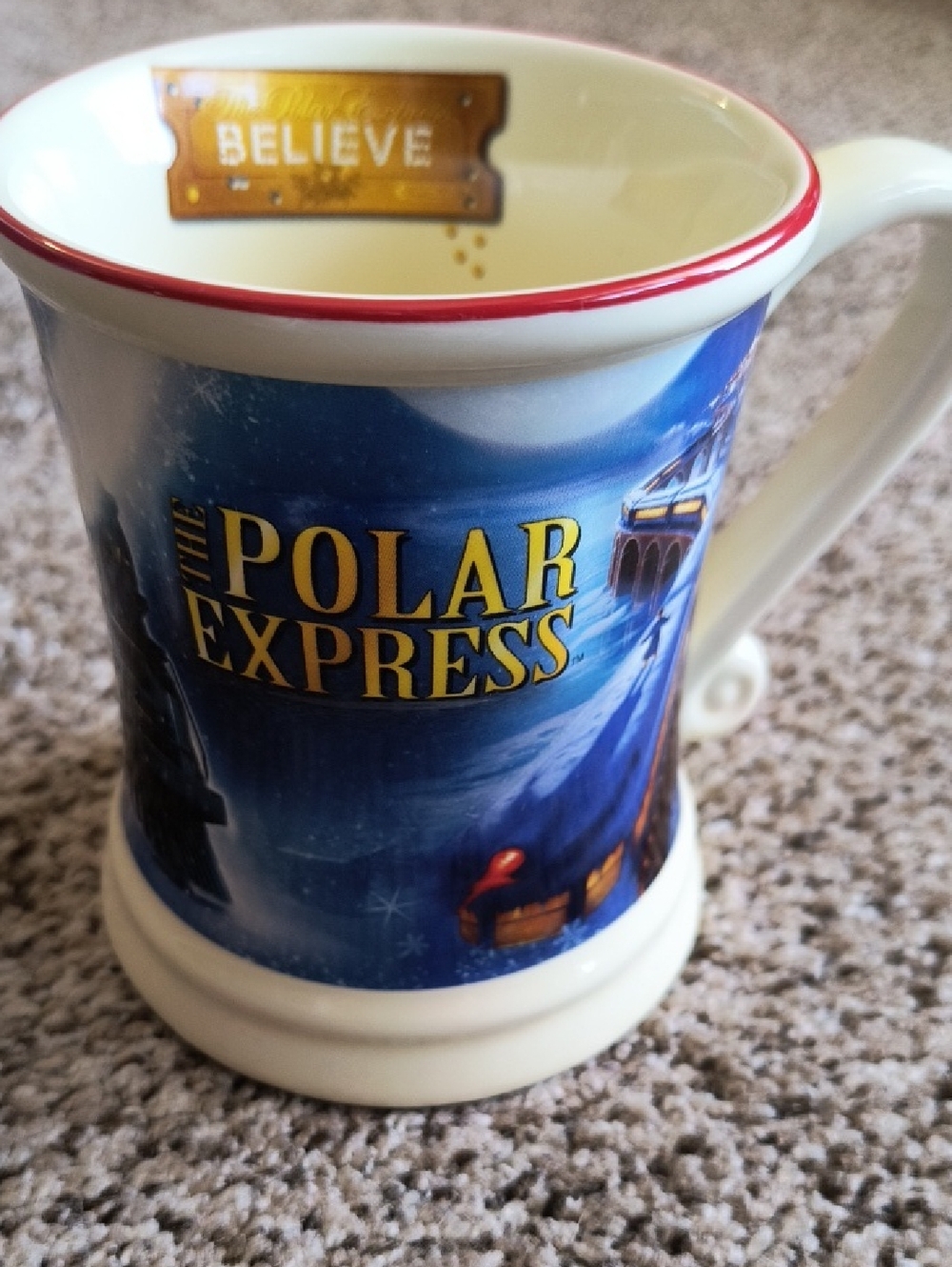 Polar Express Holiday Ceramic Mug in Cream with Blue Artwork and Red Rim